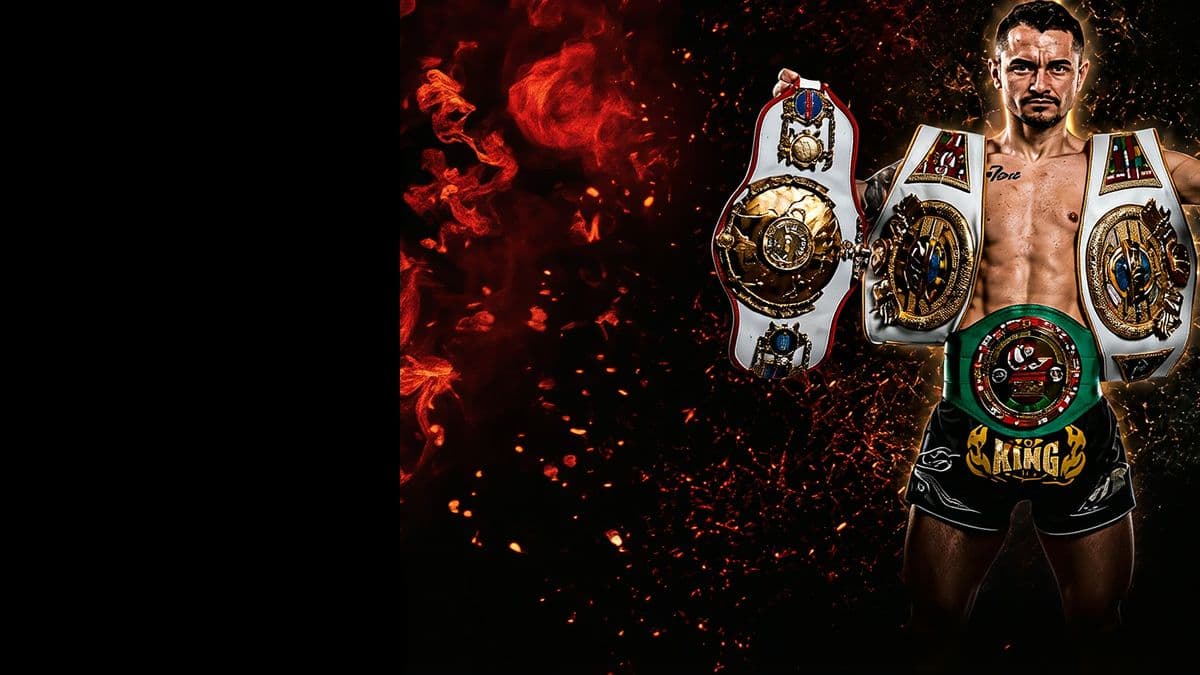Two Muay Thai champions with their belts and their coach, embers and smoke behind them