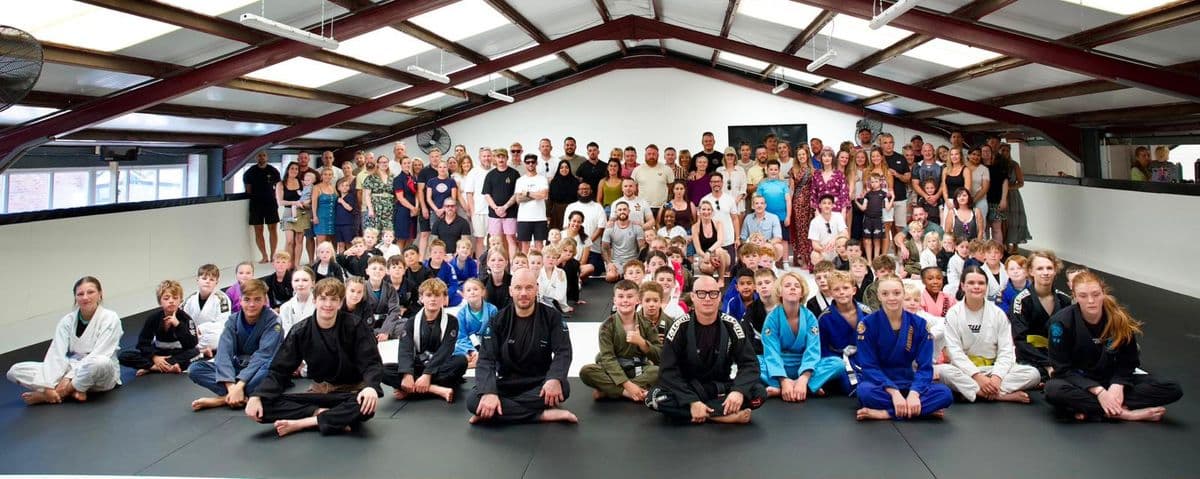 Kids, parents and coaches gathered on the mat for the SWBJJ family day