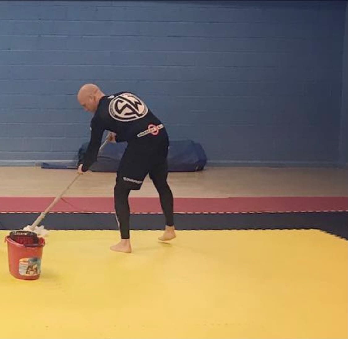 Sonny Weston mopping the mats before class